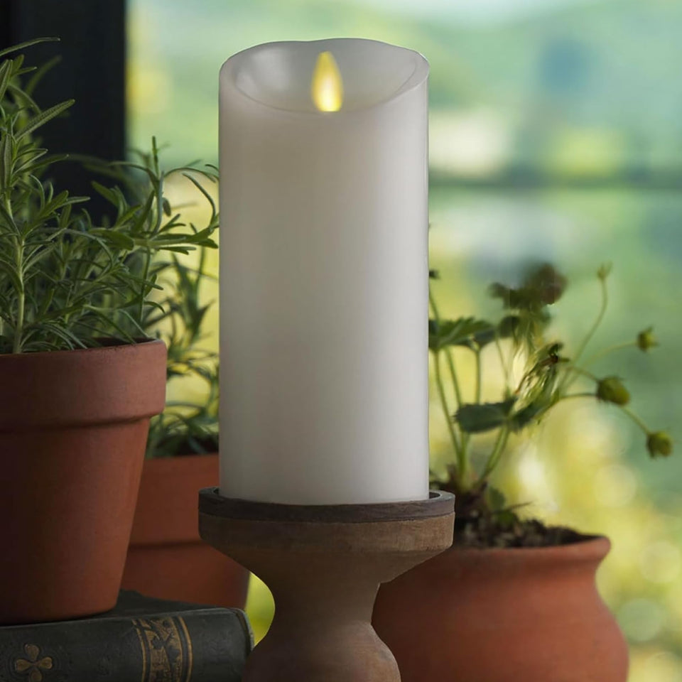 Luminara 4-5 inch white pillar candle with moving flame for cozy indoor lighting.