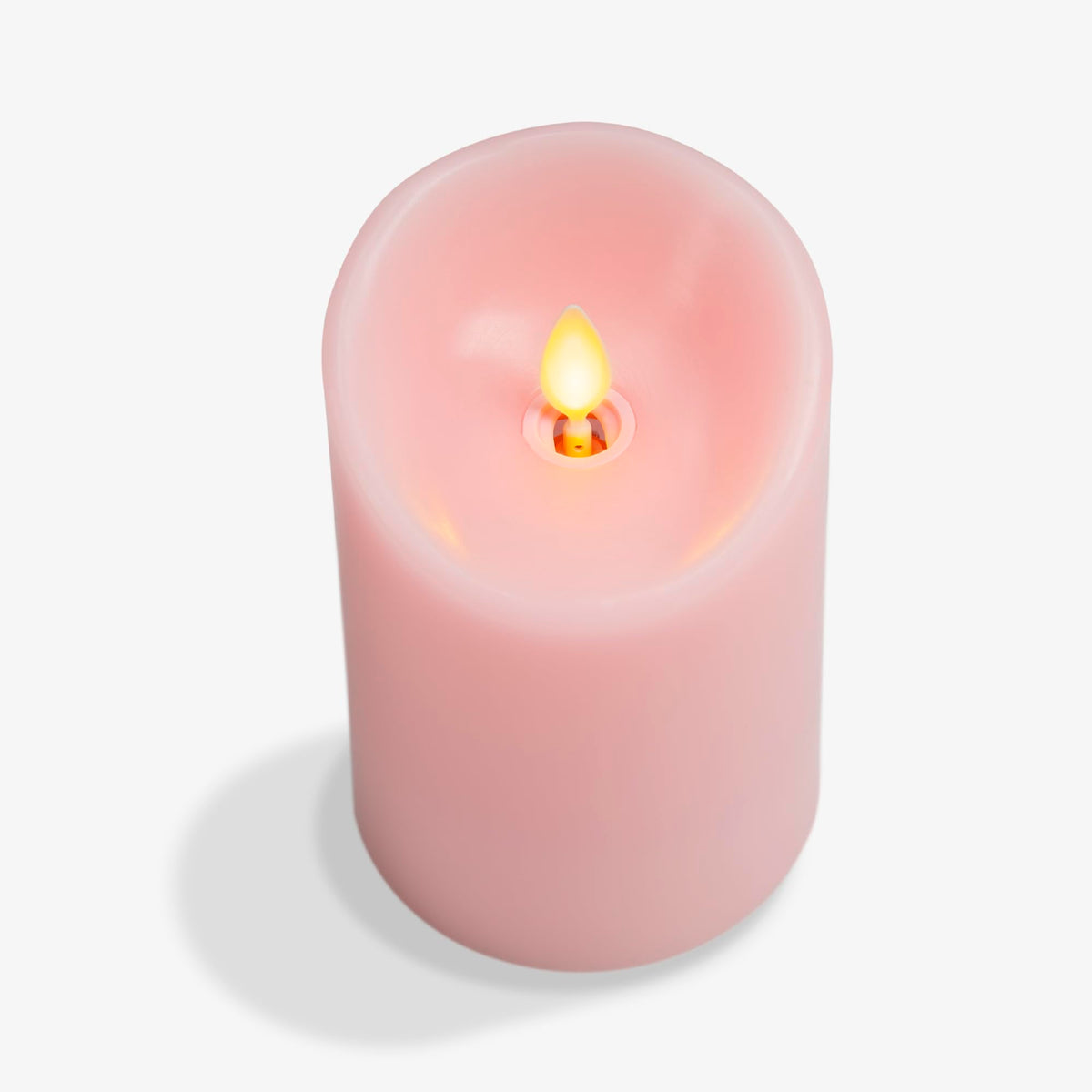 Luminara Saga Rose candle on table creates cozy safe lighting for year-round use