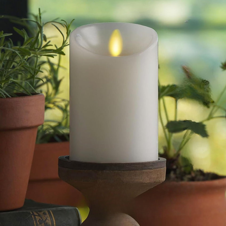 Luminara white 4.5-in pillar candle with realistic glow for cozy indoor décor.