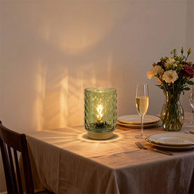 Miniature emerald lamp adding warmth to a coffee table