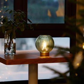 LUSHARBOR cordless table lamp on a bedside table for cozy nighttime reading.