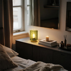 Emerald green ribbed glass glow enhances evening atmosphere