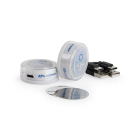 LuxPro rechargeable puck light charging via USB for cordless use.