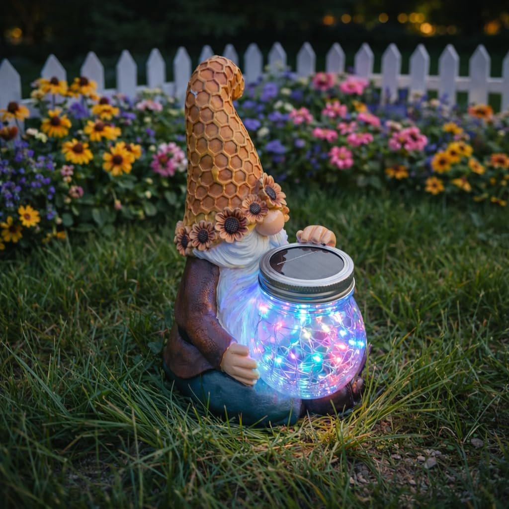 Lyeasw solar-powered gnome garden decor glows outdoors at night.