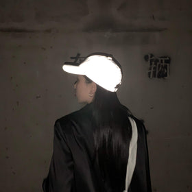 LZLRUN reflective hat tested with a phone light for brightness.