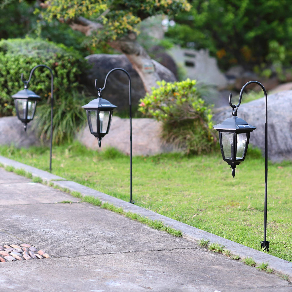 MAGGIFT lanterns on a path highlight garden entrances