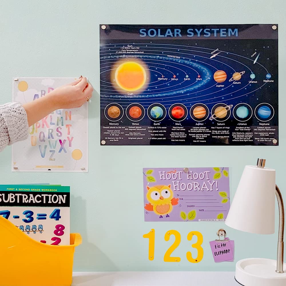 Magnetize-It! magnetic wall surface demonstrated with framed photos and magnets.