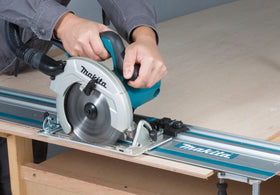 Makita 55-inch guide rail mounted on table for accurate sheet material ripping