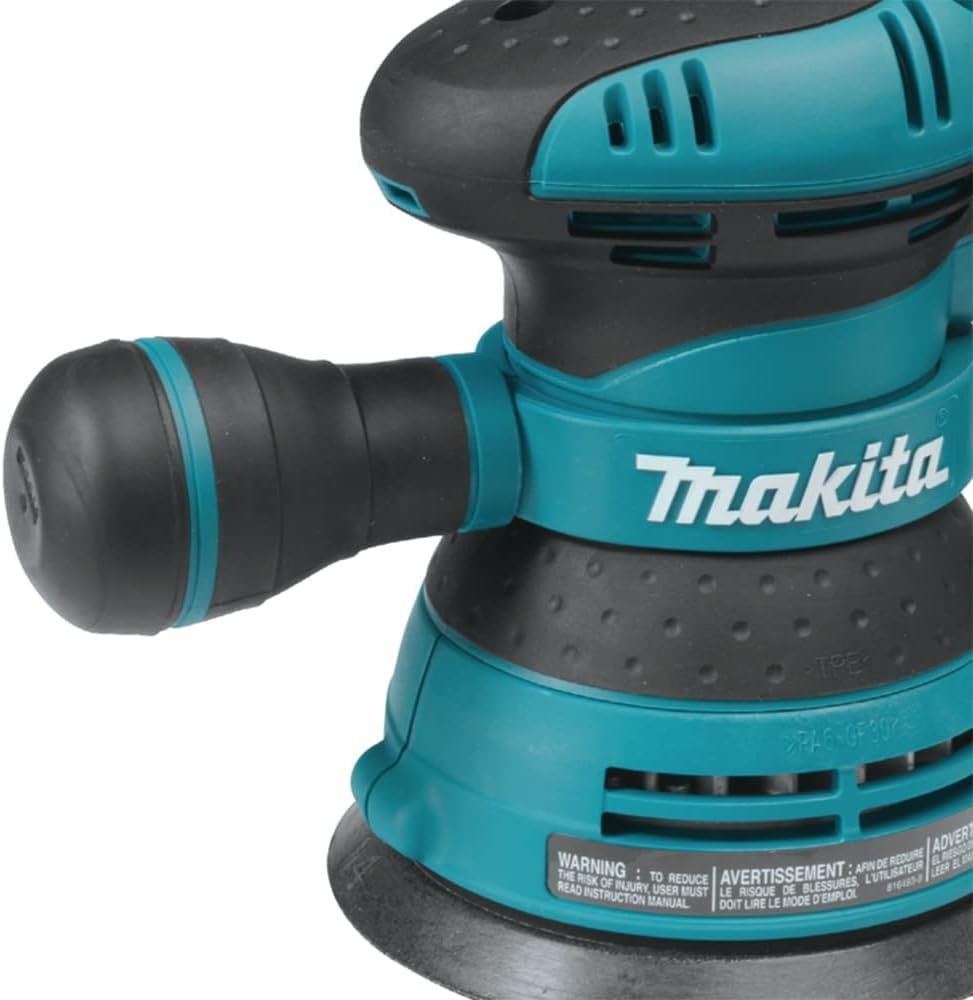 Through-the-pad dust collection on Makita BO5041K keeps workspace clean.