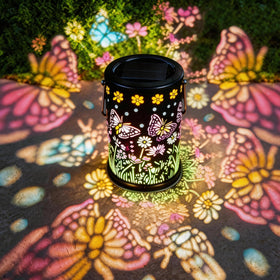 Mantunt solar lantern with butterfly pattern lighting a garden path warmly.