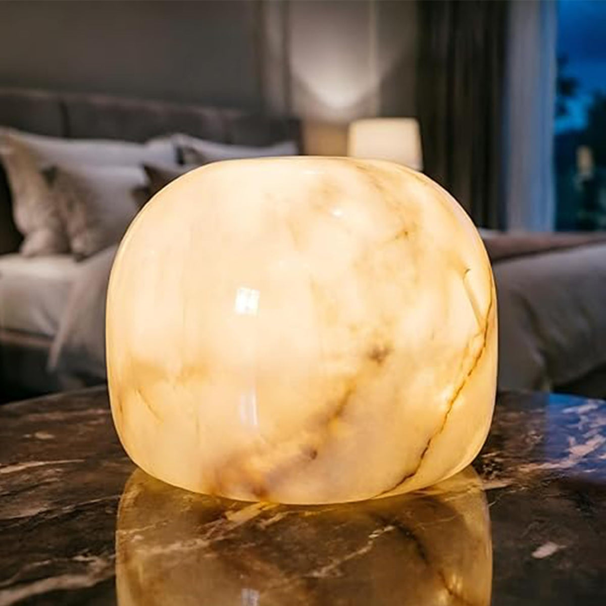 Marmor Marble Lamp night light on bedside table with a gentle ambient glow.