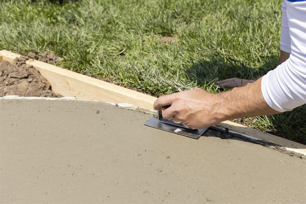 Curved-edger in action shaping a fresh concrete edge.