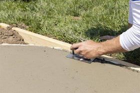 Curved-edger in action shaping a fresh concrete edge.