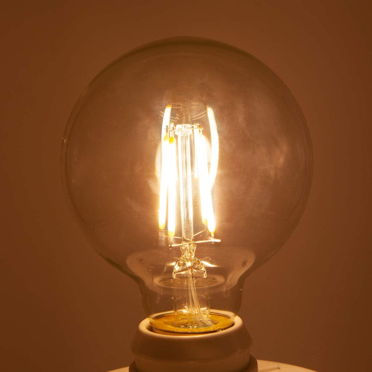 Maxxima G25 filament vanity bulb emits warm 2700K light for bathrooms