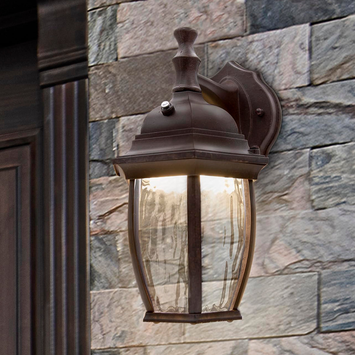 Aged bronze aluminum base complements traditional home exteriors on Maxxima sconce.