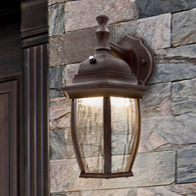 Aged bronze aluminum base complements traditional home exteriors on Maxxima sconce.