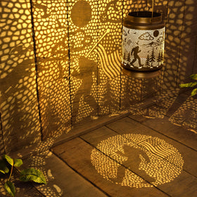 Miggley Bigfoot solar lantern hanging from a pergola creates warm outdoor ambience.