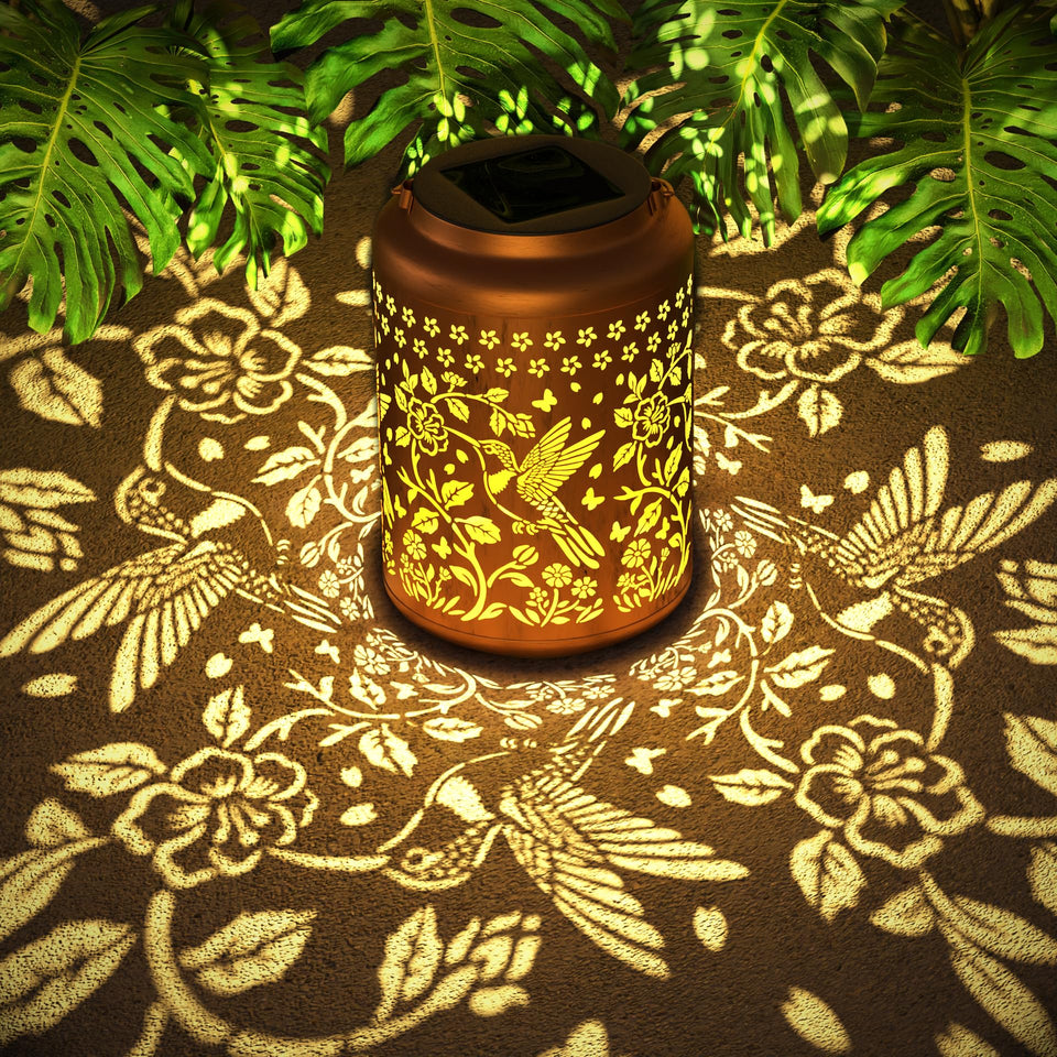 Miggley hummingbird outdoor solar lantern front view with warm garden glow.