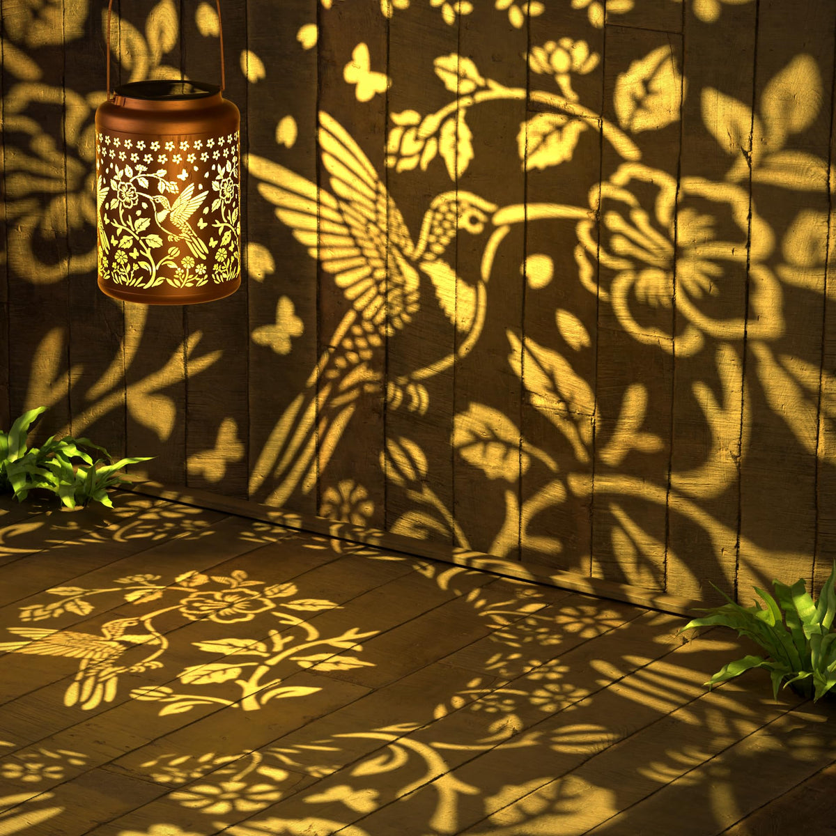 Miggley hummingbird projection lantern at night for cozy patios and pathways.