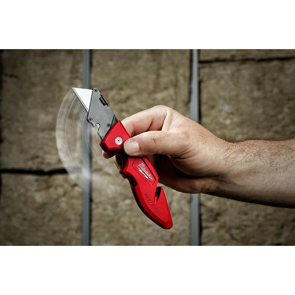 Milwaukee Fastback knife on worksite highlights rugged, reliable tool.