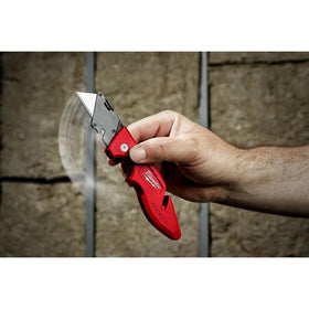 Milwaukee Fastback knife on worksite highlights rugged, reliable tool.