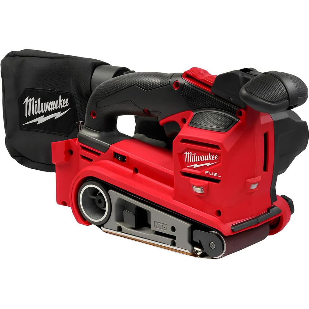 Milwaukee M18 FUEL 3x18 belt sander on wood, showing belt contact and dust collection