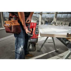 Milwaukee M18 FUEL flush sanding with front pommel against a surface