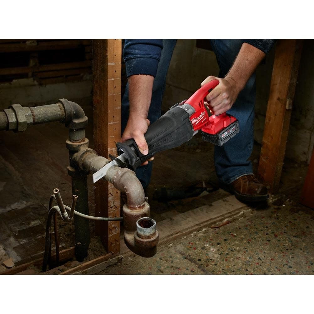 Milwaukee Torch blade in use on pipes and channels for efficient metal cutting.