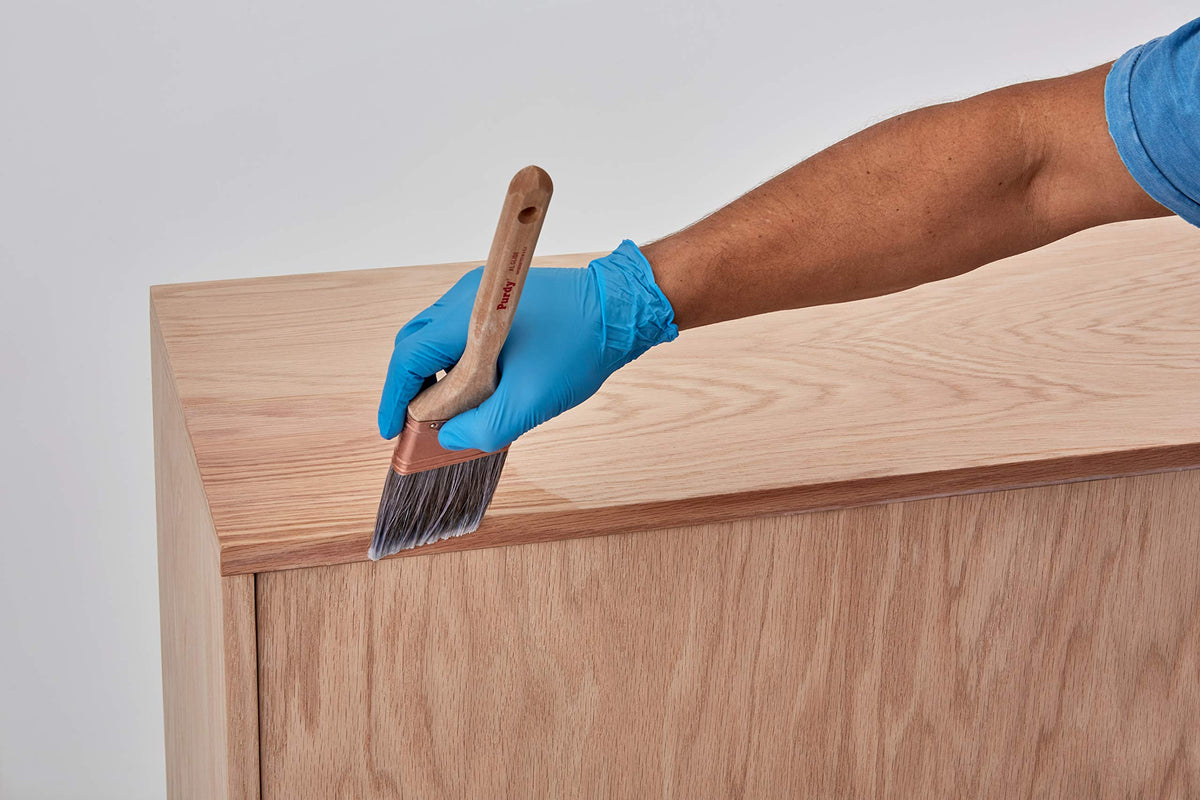 Minwax Pre-Stain Conditioner brush application for even grain fill.