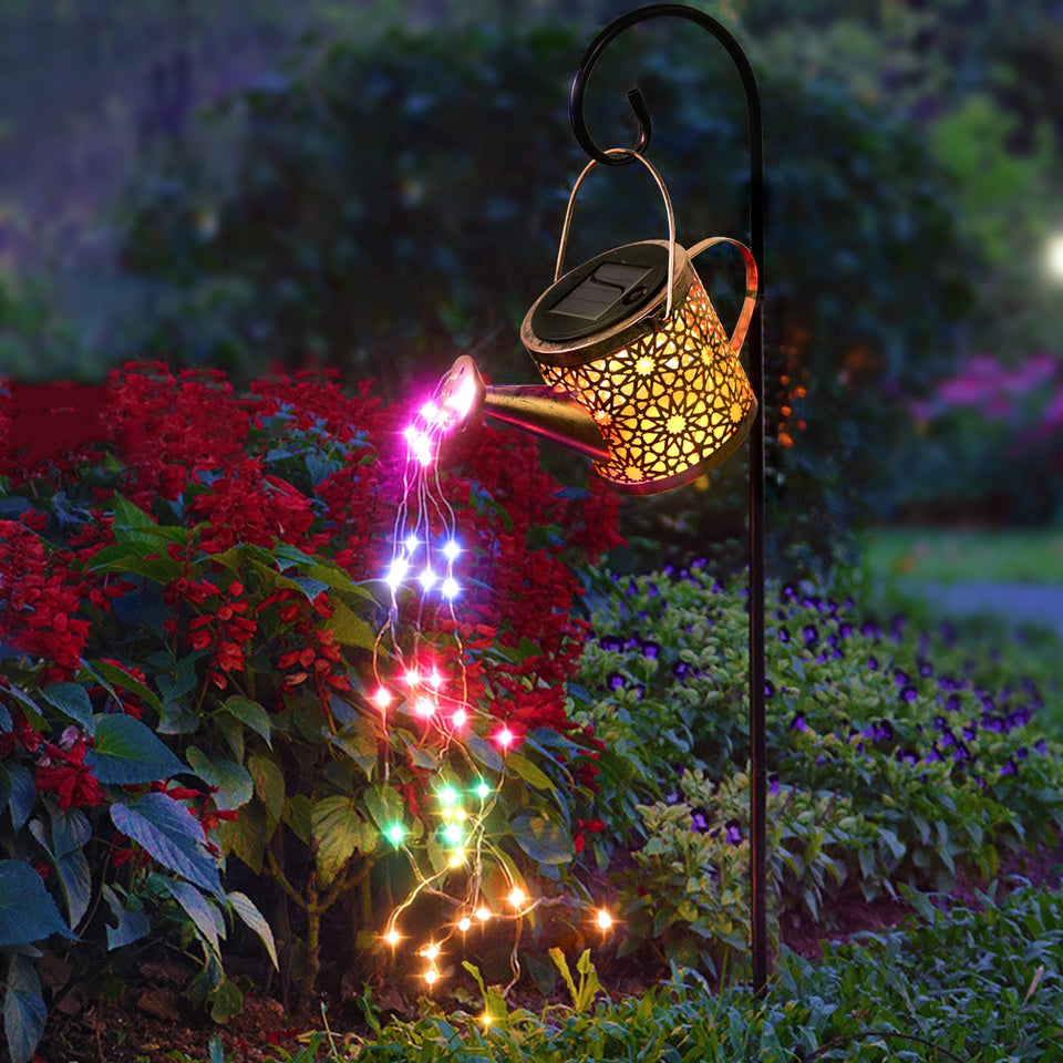 Misawce solar watering can lights outdoors with bronze finish illuminate pathways at night.