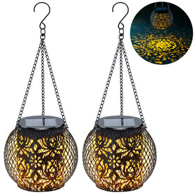 Mizmakp solar lantern hanging with lotus pattern creating warm garden glow.