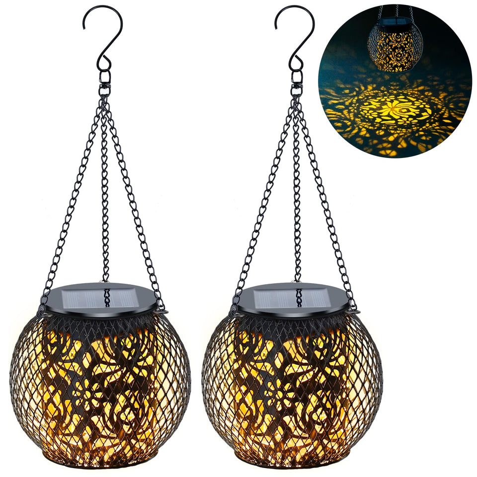 Mizmakp solar lantern hanging with lotus pattern creating warm garden glow.