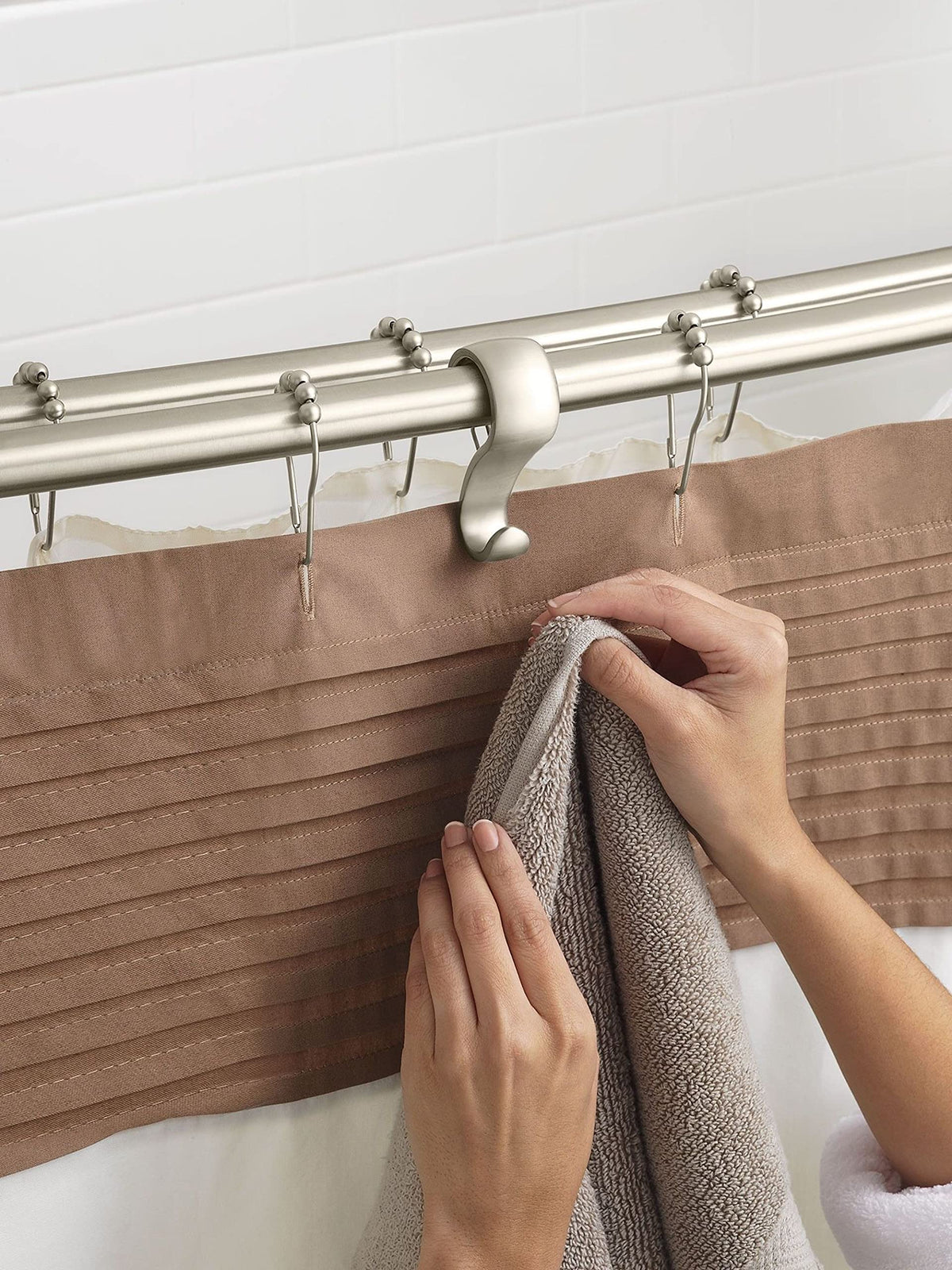 Moen curved rod installed in a bathroom setup with wall brackets