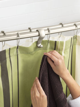 Moen brushed nickel double curved rod demonstrates added elbow room in the shower