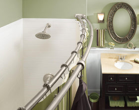 Moen curved shower rod highlighting towel hanging space in a bath