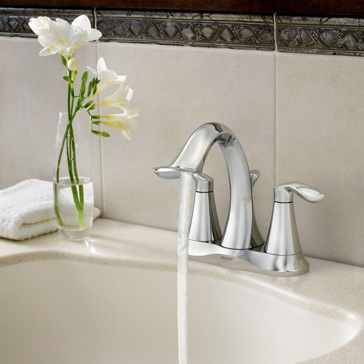 Moen Eva chrome faucet spout view highlighting elegant curve for a modern bathroom and smooth water flow.