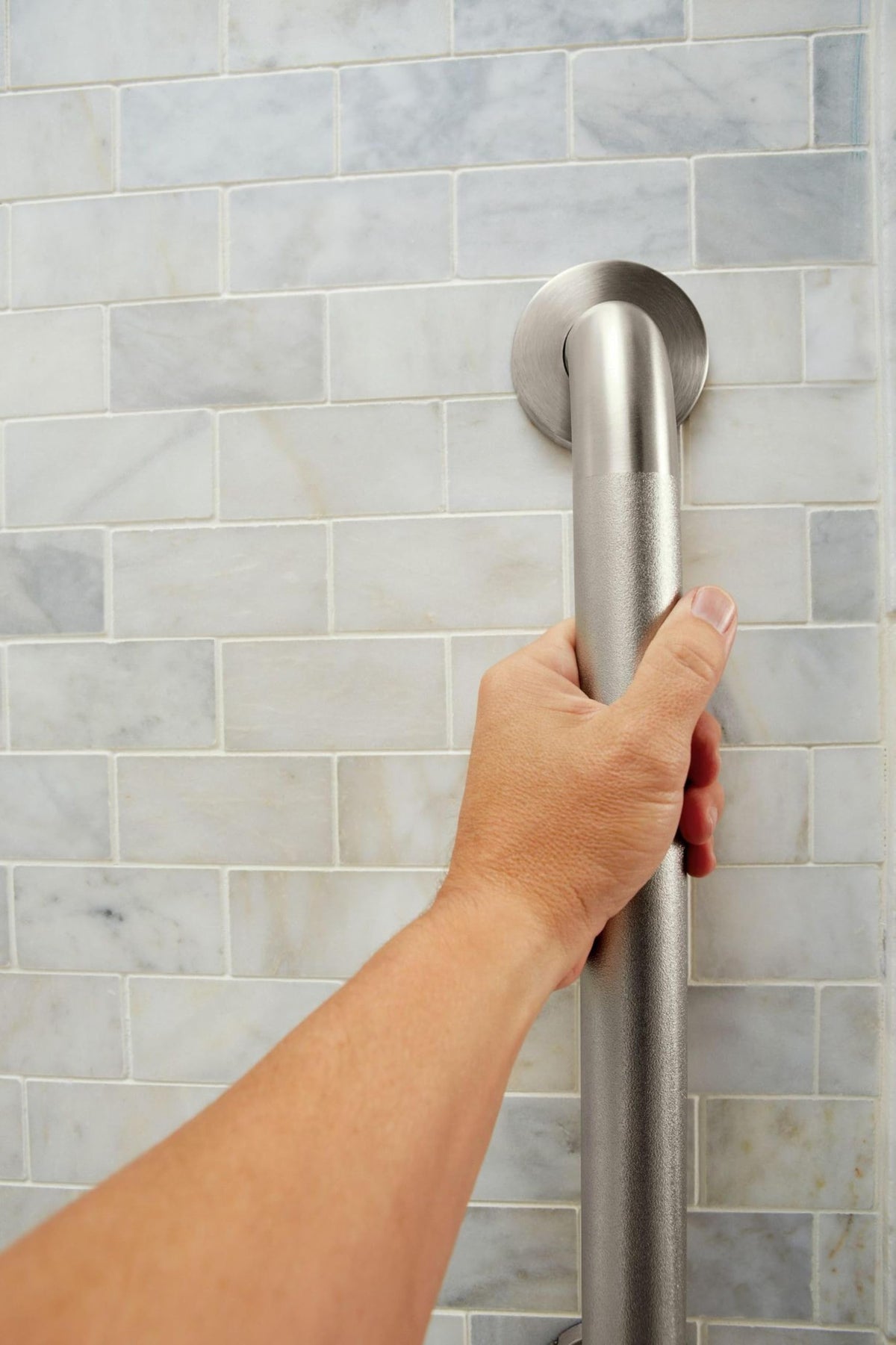 Moen polished brass finish grab bar matching modern bathroom hardware