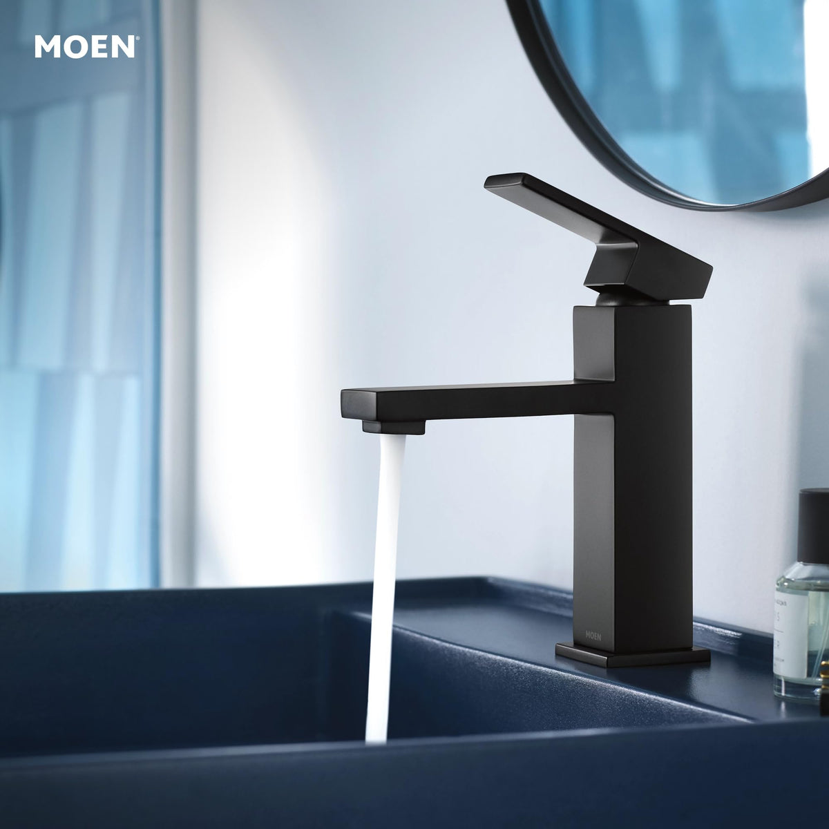 Moen Revyl spring-loaded drain closeup highlights convenient drainage with a simple push.