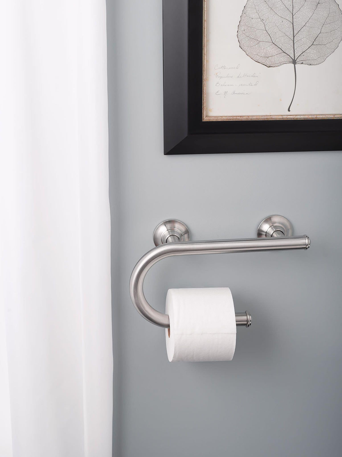 Stainless steel Moen grab bar complements bathroom with durable build