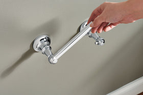 Moen Vale chrome toilet paper holder with mirror-like finish for versatile style.