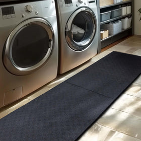 Mohawk Home mat under dog crate protects floors from daily wear and tear