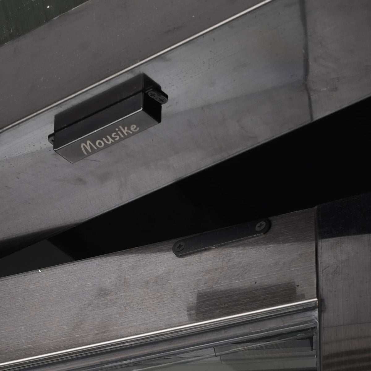 Mousike drawer/door latch showing robust magnetic hold.