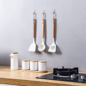 Movelyst hooks on glass surface proving clutter-free entryway organization.