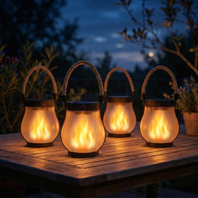 MYLLIUIM flame-style solar lantern on a table for cozy outdoor ambience.