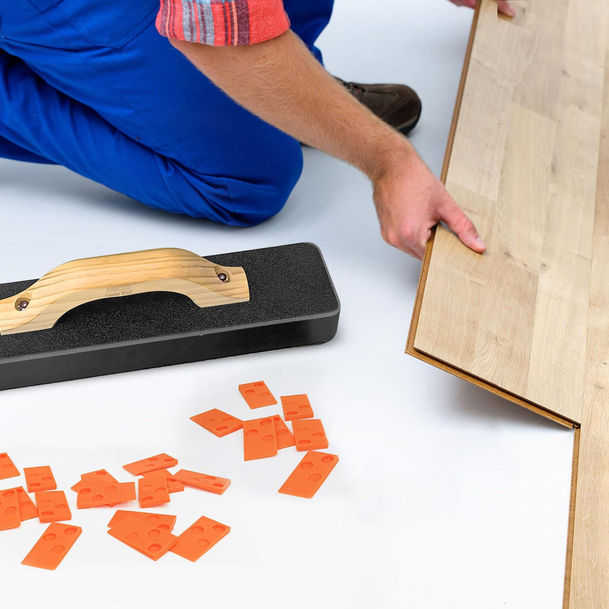 NAACOO tapping block and pull bar kit in action during floor install