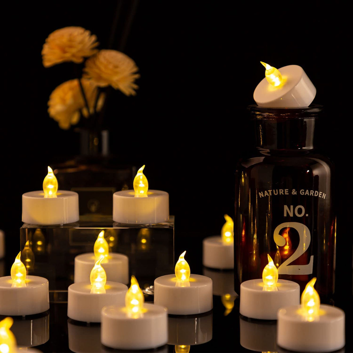 Nancia tea lights lit in holder creating intimate dinner glow