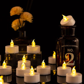 Nancia tea lights lit in holder creating intimate dinner glow