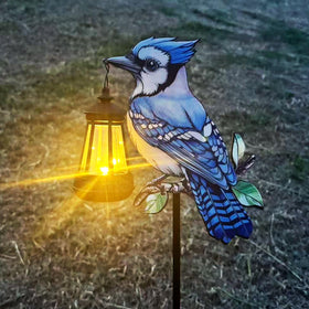 Nanzhujin Blue Jay solar lantern on a stake adds subtle evening garden lighting.