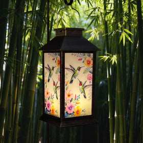 Nanzhujin solar lantern with hummingbird pattern glowing in the garden