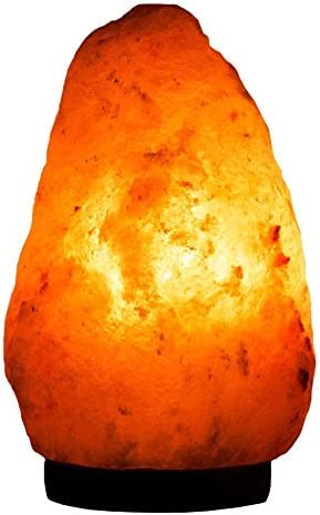 Hand-carved wooden base supports Needs&Gifts Himalayan salt lamp.